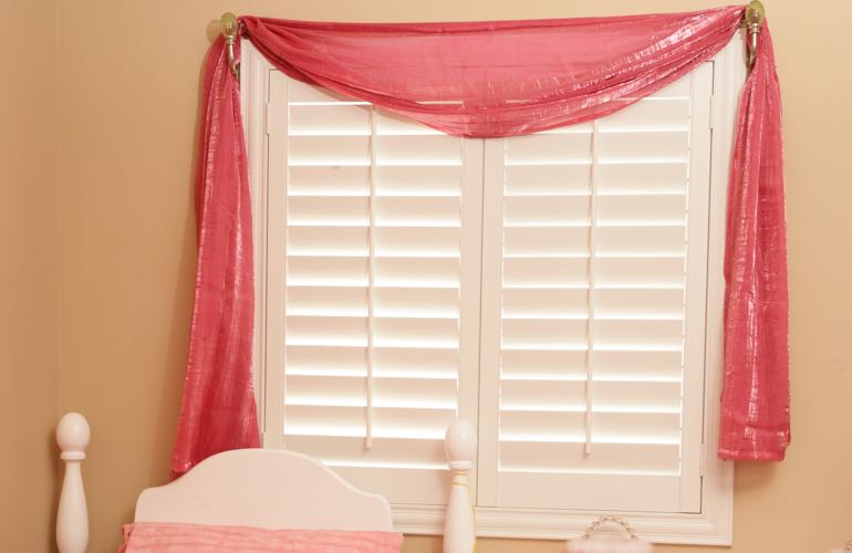 Child's bedroom with white shutters.